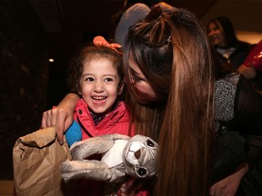Syrian refugee Maysa Yousef, 3, is greeted at the Calgary International Airport by family member Mishleen William.