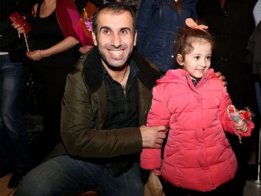 Ashour Esho greets his cousin's little girl, Syrian refugee Maysa Yousef, 3, at the Calgary International Airport on Nov. 23, 2015.