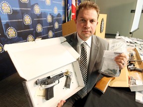 Calgary Police Service Staff Sgt. Martin Schiavetta, of the CPS Drug Unit, spoke about a two-month-long investigation where three people have been charged in relation to a drug operation into a complex investigation took place into a suspected fentanyl trafficking ring. He was photographed with a 9 mm handgun, which was loaded at the time of the bust, and a bag of seized fentanyl at the Westwinds headquarters on Nov. 26, 2015.