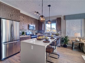 Kitchen and dining area in the Fish Creek 2 show suite at Cranston Ridge by Cardel Lifestyles.