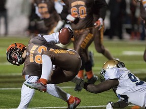 St. Francis Browns Jacob Izquierdo gets tackled by Notre Dame Pride Tanaka Mutahno during the Alberta Bowl Provincial Final for Tier 1 schools at Foote Field, in Edmonton November 28, 2015. The Browns won 38-28.