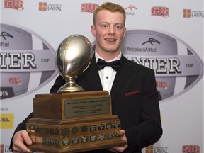 Andrew Buckley, a fifth-year quarterback from the University of Calgary, holds the Hec Crighton Trophy as the outstanding player in CIS football on Thursday in Quebec City. It's the second-straight time he has won the award.