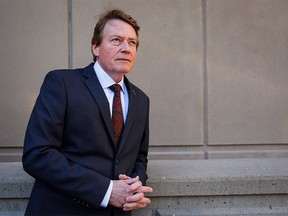 Former TV journalist Arthur Kent pauses outside court during a break in his lawsuit against Postmedia and other individuals related to a 2008 column, in Calgary on Monday, Nov. 16, 2015.