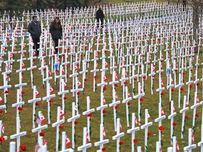 Calgarians walk through the Field of Crosses along Memorial Drive on Monday, Nov. 2, 2015. The annual memorial contains over 3,200 crosses honouring southern Albertans who died for Canada.