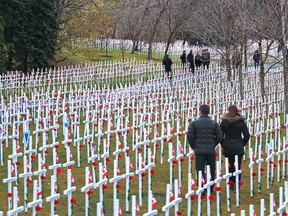 Calgarians walk through the Field of Crosses along Memorial Drive on Monday, Nov. 2, 2015. The annual memorial contains over 3,200 crosses honouring southern Albertans who died for Canada.