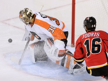 Calgary Flames centre Josh Jooris scored on Philadelphia Flyers goaltender Michal Neuvirth just seconds after this first attempt during the first period of NHL action at the Scotiabank Saddledome on Thursday Nov. 5, 2015