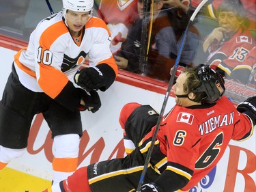 Philadelphia Flyers' Brayden Schenn collides with Calgary Flames defensemen Dennis Wideman during the second period of NHL action at the Scotiabank Saddledome on Thursday Nov. 5, 2015