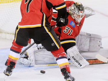 Calgary Flames goaltender Karri Ramo looks for the loose puck during the first period of NHL action at the Scotiabank Saddledome on Thursday Nov. 5, 2015