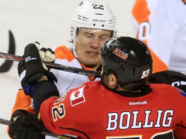 The Philadelphia Flyers' Luck Schenn and the Calgary Flames' Brandon Bollig wrestle during the third period of NHL action at the Scotiabank Saddledome on Thursday Nov. 5, 2015