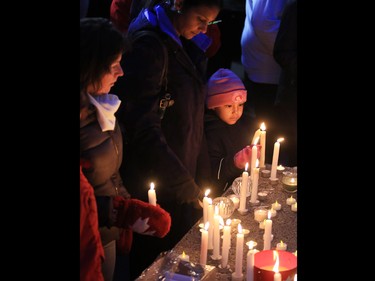 Calgarians attend a candlelight vigil for the victims of the terrorist attack in Paris. The vigil took place outside City Hall in Calgary on Saturday night November 14, 2015.