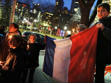 The De Fosseux family from Paris was among about 100 people who attended a candlelight vigil for the victims of the terrorist attack in Paris. The vigil took place outside City Hall in Calgary on Saturday night November 14, 2015.
