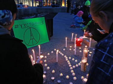 Calgarians attend a candlelight vigil for the victims of the terrorist attack in Paris. The vigil took place outside City Hall in Calgary on Saturday night November 14, 2015.