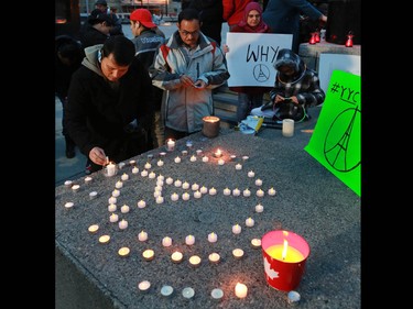 Calgarians attend a candlelight vigil for the victims of the terrorist attack in Paris. The vigil took place outside City Hall in Calgary on Saturday night November 14, 2015.