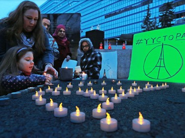 Calgarians attend a candlelight vigil for the victims of the terrorist attack in Paris. The vigil took place outside City Hall in Calgary on Saturday night November 14, 2015.