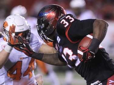 Calgary Stampeders running back Jerome Messam runs the ball against B.C. Lions linebacker Adam Bighill in the second half of the CFL's West Division semifinal at McMahon Stadium. Calgary won the game 35-9.