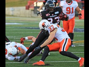 Calgary Stampeders running back Jerome Messam runs the ball in for a touchdown during the first half of the CFL's West Division semifinal against the B.C. Lions at McMahon Stadium.