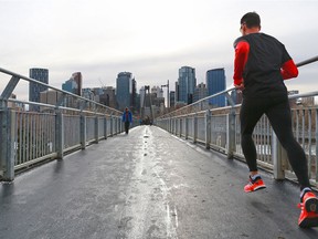 A runner crosses over the bridge to Prince's Island on Tuesday, Nov. 17.