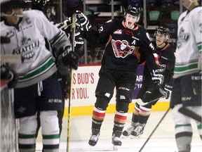 Calgary Hitmen defenceman Travis Sanheim slaps hands at the bench after his second period goal against the Seattle Thunderbirds on Sunday.