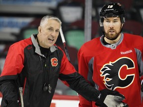 Calgary Flames head coach Bob Hartley talks with winger David Jones during practice at the Saddledome Nov. 19, 2015.