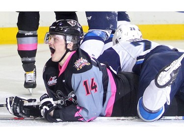 Layne Bensmiller of the Calgary Hitmen comes up smiling after scoring on the Saskatoon Blades in the second period at the Saddledome Sunday afternoon November 22, 2015.