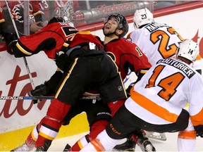 Calgary Flame Josh Jooris battles Philadelphia Flyer Brandon Manning at the Scotiabank Saddledome on Thursday. Reader is tired of all the talk of trades and wants to see some wins.