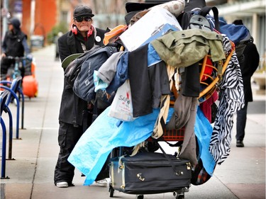 Daniel K pushes his cart full of his possessions through the streets of Calgary on November 12, 2015.