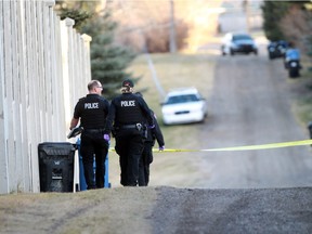 Police investigate after a body was found in the alley behind the 400 block of Hendon Drive N.W. on Sunday. November 15, 2015.