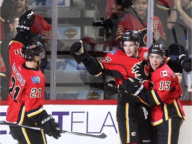 Calgary Flames Sean Monahan, middle, celebrates his goal on Chicago Blackhawks with teammates Mason Raymond, left, and Johnny Gaudreau during their game at the Scotiabank Saddledome in Calgary on November 20, 2015.