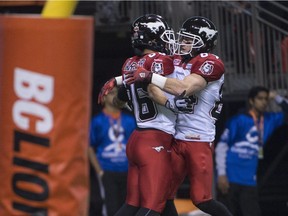 Calgary Stampeders' Anthony Parker, left, celebrates his touchdown with teammate Greg Wilson against the B.C. Lions on Saturday.