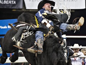 Jake Vold takes part in the bareback riding event during the 42nd Canadian Finals Rodeo at Rexall Place in Edmonton, Alta., on Friday, Nov. 13, 2015.