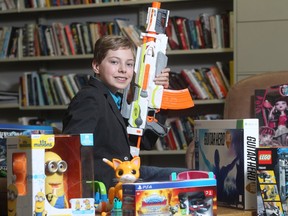 Alex Thorne, Chief Play Officer with Toys R Us, brandishes a Nerf Blaster, while showing off the holiday season's hottest items at the Calgary Herald Thursday November 12, 2015.