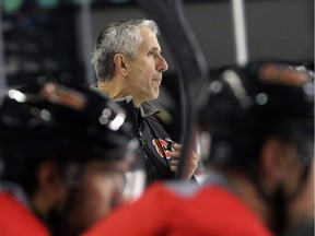 Calgary Flames head coach Bob Hartley instructs his team during practice at the Scotiabank Saddledome on Monday. The slumping squad hosts the New Jersey Devils on Tuesday.