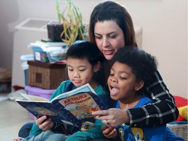 EvenStart for Children teacher Brianna Parkhill reads to two boys in the in one of the foundation's classrooms on Thursday November 12, 2015.