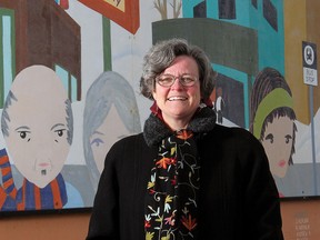 In this 2011 file photo Cheri Macaulay stands next to one of the many murals she helped intiate in her neighbourhood of Brentwood.