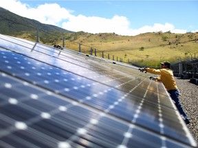 GUANACASTE, COSTA RICA - MARCH 26:  A worker cleans the panels in a solar power park run by the Costa Rican Electricity Institute (ICE) as the power company has managed to produce all of the electricity for the nation from renewable energy sources for more than 80 days straight on March 26, 2015 in Guanacaste, Costa Rica. The milestone has been reached with the use of hydroelectric power plants and a combination of wind, solar, and geothermal energy.