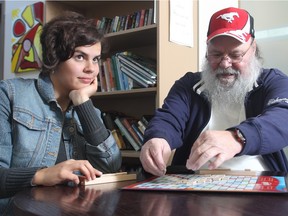 Alex Hupe lays down his letters during a game of Scrabble with volunteer Erica Bayley at the Alex Community Health Centre on Wednesday October 28, 2015. Formerly illiterate, he says his life has been transformed by the centre, and now has learned how to read and write. The two get together to play a game of Scrabble every week.