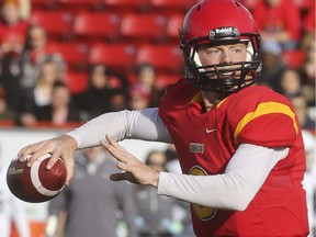 Calgary Dinos' quarterback Andrew Buckley makes a pass during playoff action against the Sask Huskies at McMahon Stadium in Calgary, on November 7, 2015.