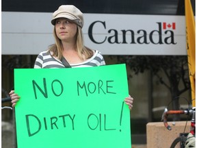 Anti-Keystone pipeline and oilsands protestor Robyn Luff held a sign as she gathered with other protestors outside the Harry Hays Building in Calgary on Sept. 26, 2011. to voice their opposition to the project. In May, Luff became an NDP MLA in the riding of Calgary-East.