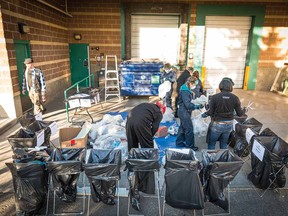 Mountain Equipment Co-op employees sorting through their garbage bin.