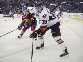 Aaron Irving of the Edmonton Oil Kings, moves in on Radel Fazleev of the Calgary HItmen during Saturday's meeting at Rexall Place. The Hitmen lost 3-2.