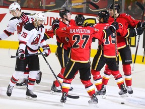 The Calgary Flames cheer after Matt Stajan's goal on the New Jersey Devils at the Scotiabank Saddledome made it 2-0 in favour of the home side on Tuesday night. The Flames hung on for a crucial 3-2 victory.