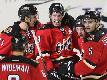 The Calgary Flames cheer after scoring at the Scotiabank Saddledome in Calgary on Saturday, Nov. 7, 2015. The Flames led the Pittsburg Penguins, 3-1, in the first period of regular season play.