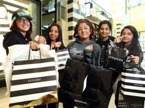 Calgary shoppers, from left, Harinder Bagri, Jaspreet Sidhu, Priya Mahey, Navpreet Sidhu and Nikki Bagri showed off their early morning haul from stores at CF Chinook Centre during the stores Black Friday sale in Calgary on November 27, 2015. The friends got to the mall before 6 am to take advantage of the deals.