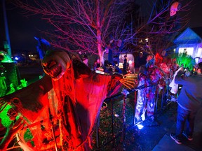 Jamie Loney's home attracts many visitors trick or treating in the community of Country Hills in Calgary on Saturday, Oct. 31, 2015.