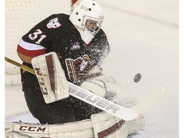 Calgary Hitmen's goalie Cody Porter makes a big save during second period action against the Regina Pats at the Saddledome in Calgary, on November 27, 2015.