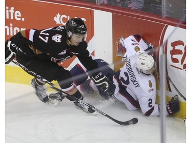 Calgary Hitmen's Jordy Stallard takes a penalty for putting Regina Pats' Sergey Zborovskiy into the boards during second period action at the Saddledome in Calgary, on November 27, 2015.