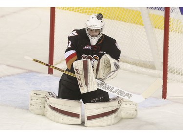 Calgary Hitmen's goalie, Cody Porter makes a save during first period action against the Regina Pats at the Saddledome in Calgary, on November 27, 2015.