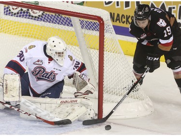 Calgary Hitmen's Radel Fazleev tries a wrap-around on Regina Pats' goalie Jordan Hollett during second period action at the Saddledome in Calgary, on November 27, 2015.