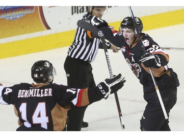 Calgary Hitmen's Travis Sanheim, right, celebrates after he ties the game with just seconds remaing in the third against the Regina Pats at the Saddledome in Calgary, on November 27, 2015.