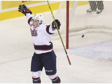 Regina Pats Jake Leschyshyn celebrates after he pockets the winning overtime goal during game action against the Calgary Hitmen at the Saddledome in Calgary, on November 27, 2015.